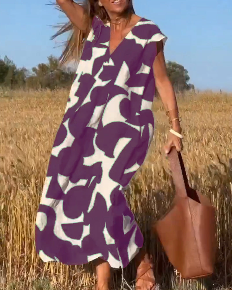 Robe mi-longue à motifs et col V plongeant